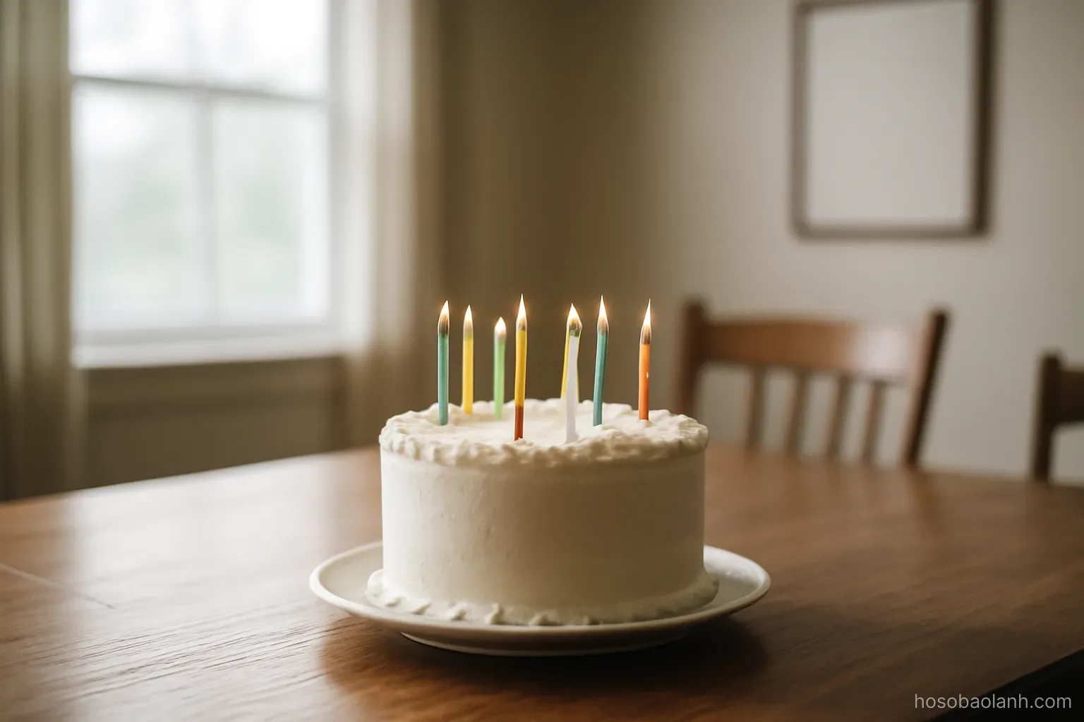 a birthday cake with unlit candles sitting untouched on a table in an empty dining room